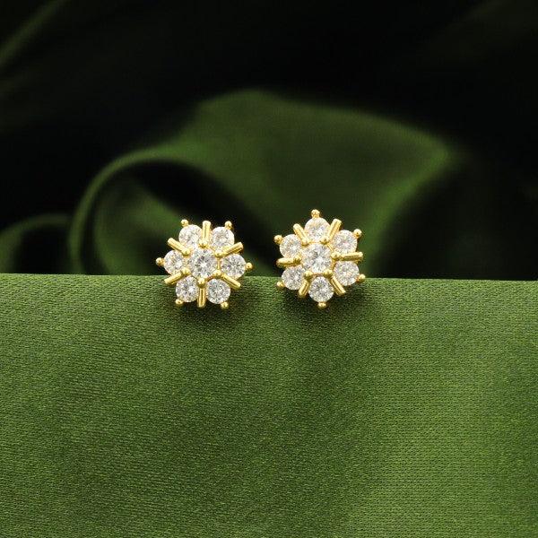 925 silver flower-shaped women's studs with sparkling stones against green background