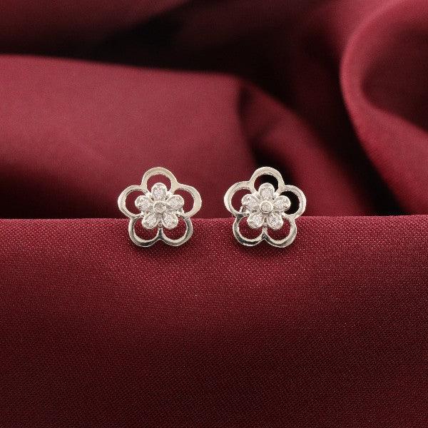 925 silver Devangana flower-shaped women's studs on maroon fabric backdrop