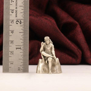 925 silver 3D Sai Baba idol weighing 32g with dimensions of 3.5cms beside a measurement scale for size reference