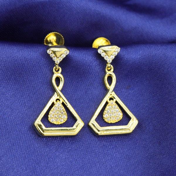 Elegant gold dangler earrings with diamond accents on a blue fabric background.