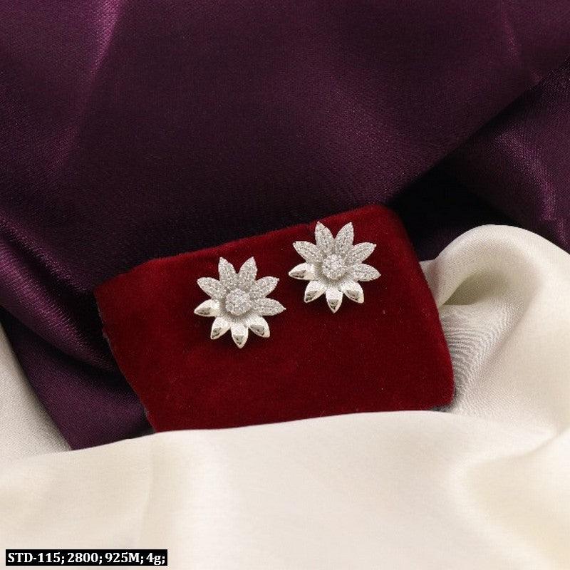 925 silver studded flower women studs STD-115, 4g, on red and white fabric backdrop.