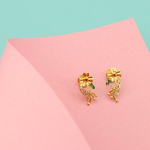 Gold flower-shaped stud earrings with green accents on pink and mint green background