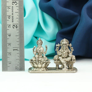 925 Silver 3D Lakshmi Ganesha idols with 4cm height and 69g weight next to a measuring scale displaying intricate detailing and craftsmanship.